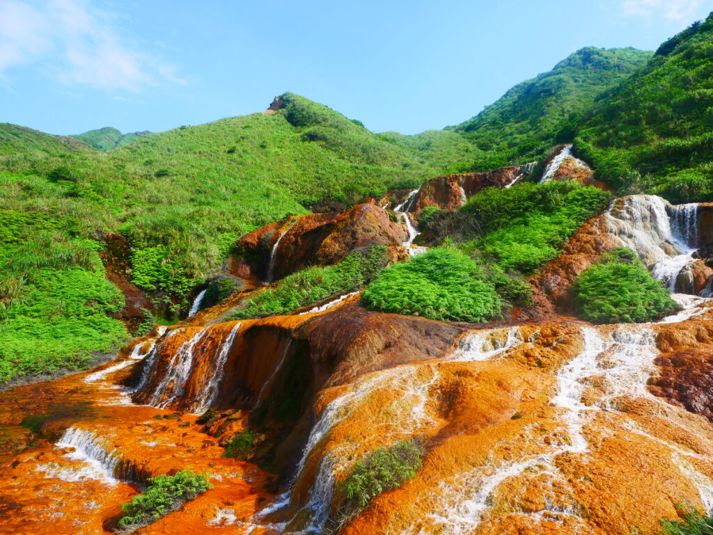 Lush green mountains with cascading waterfalls — Lumara Integrative Health. Clinical supervision for therapists.
